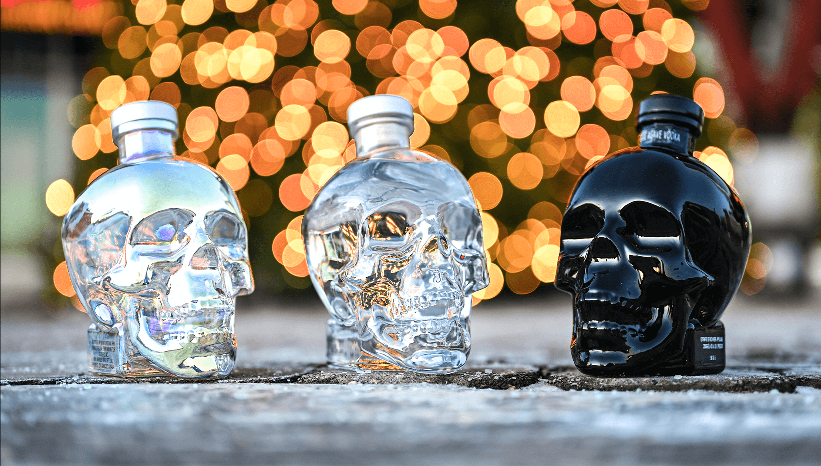 All three expressions of Crystal Head are showcased with bokeh lights in the background